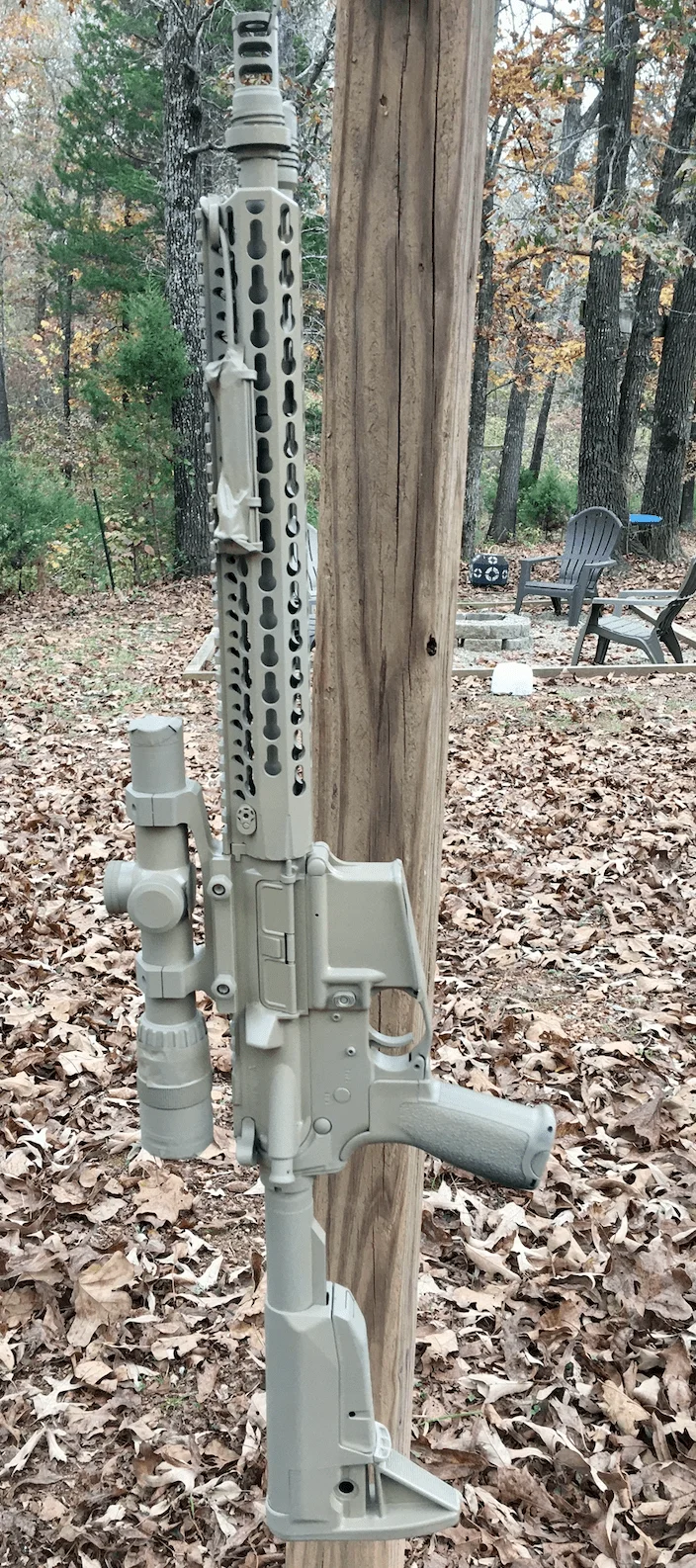 camo ar15 hanging on post for spray painting