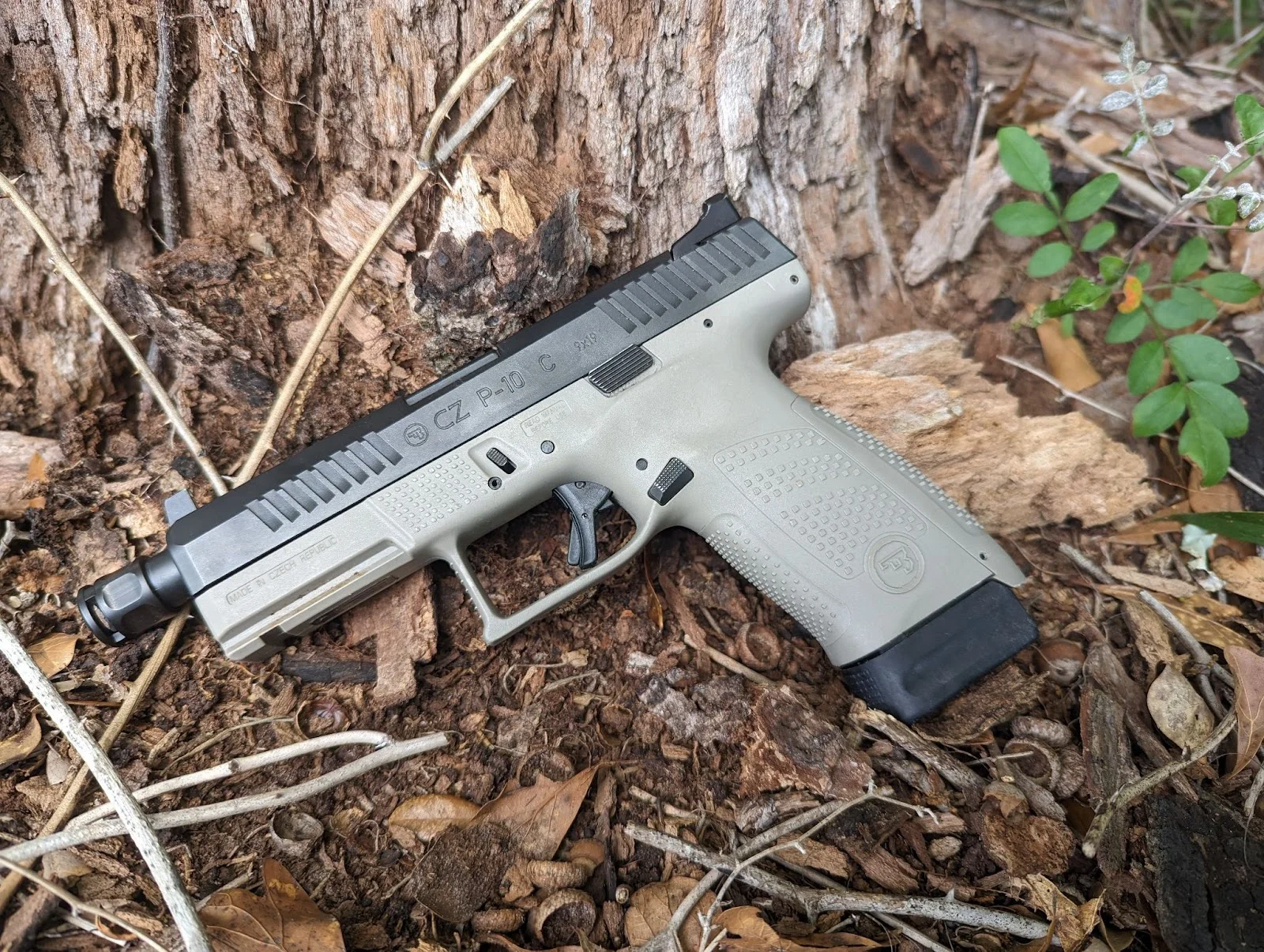 Cz p10c laying against tree
