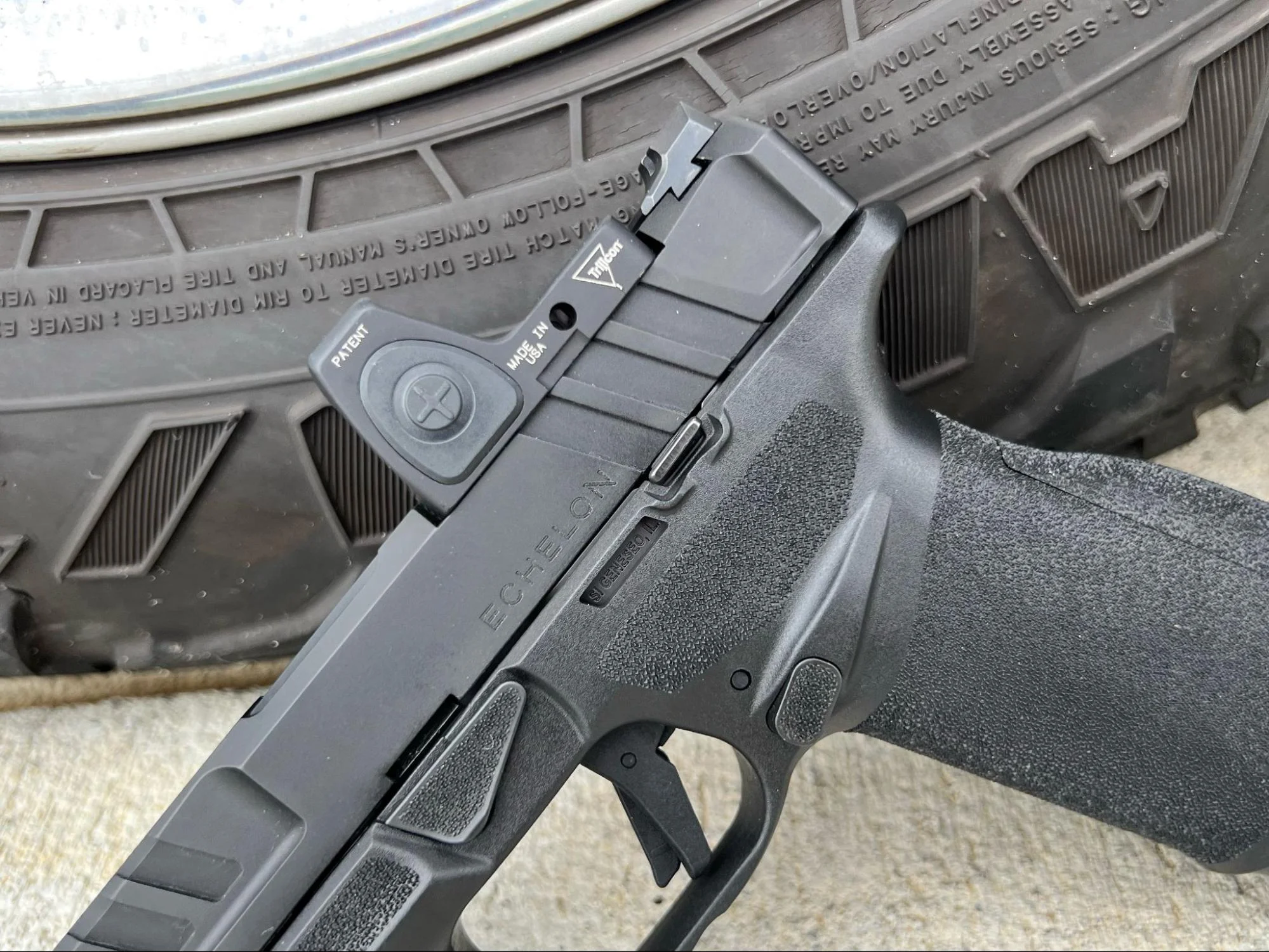 springfield armory echelon leaned against truck tire