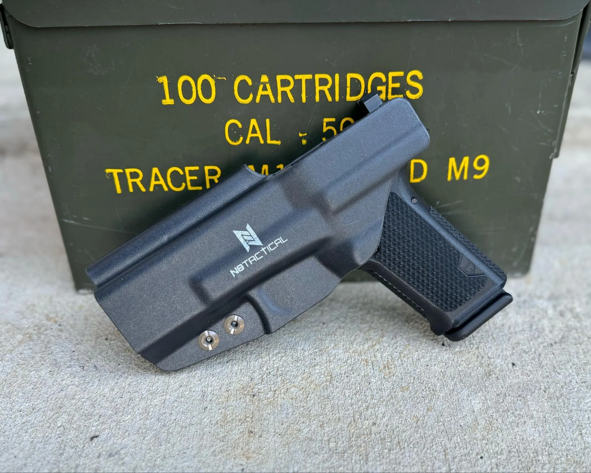 lone wolf dusk 19 leaned against ammo can and holstered n8 tactical holster