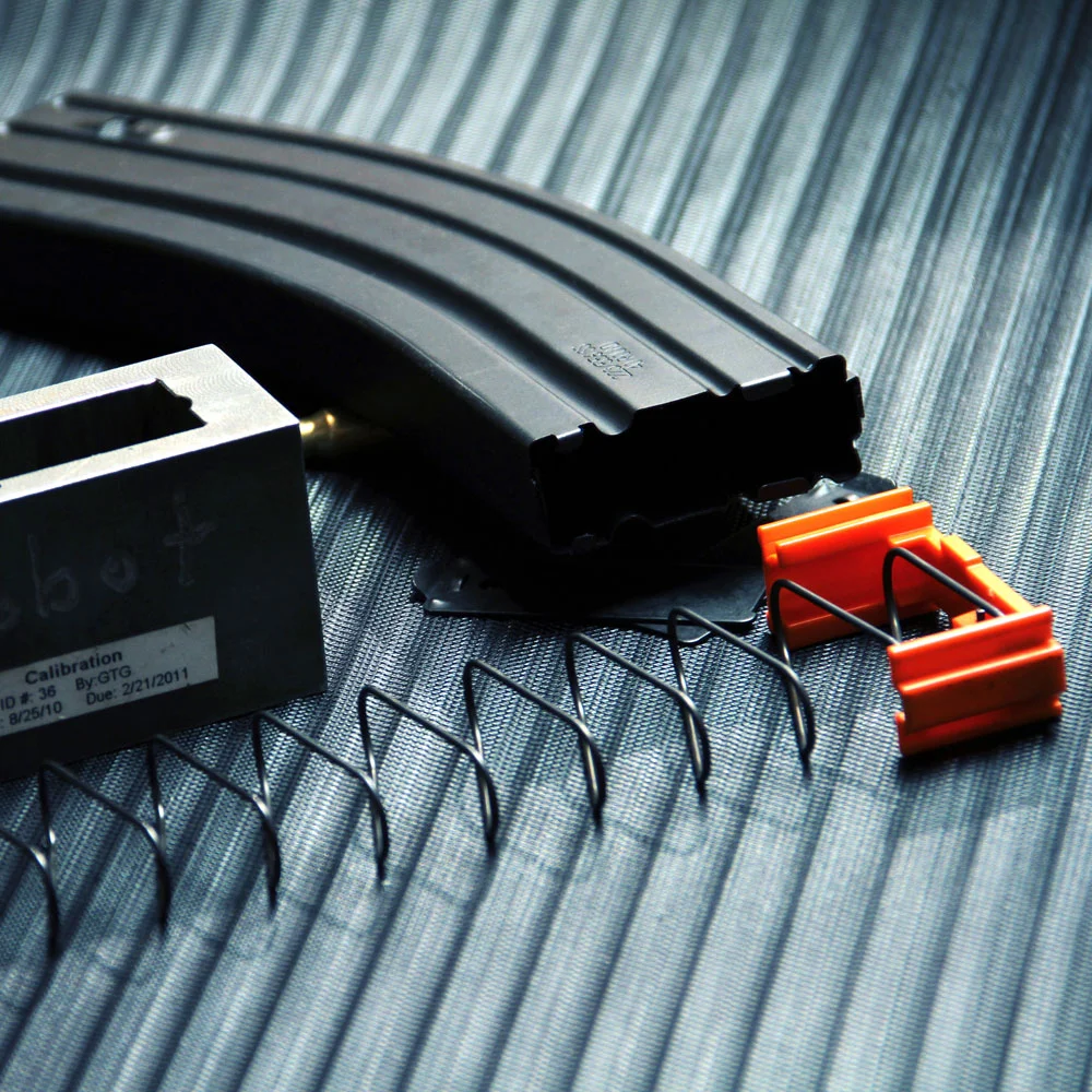 Close-up inside a DURAMAG magazine, focusing on the anti-fatigue spring designed for consistent feeding and reliability