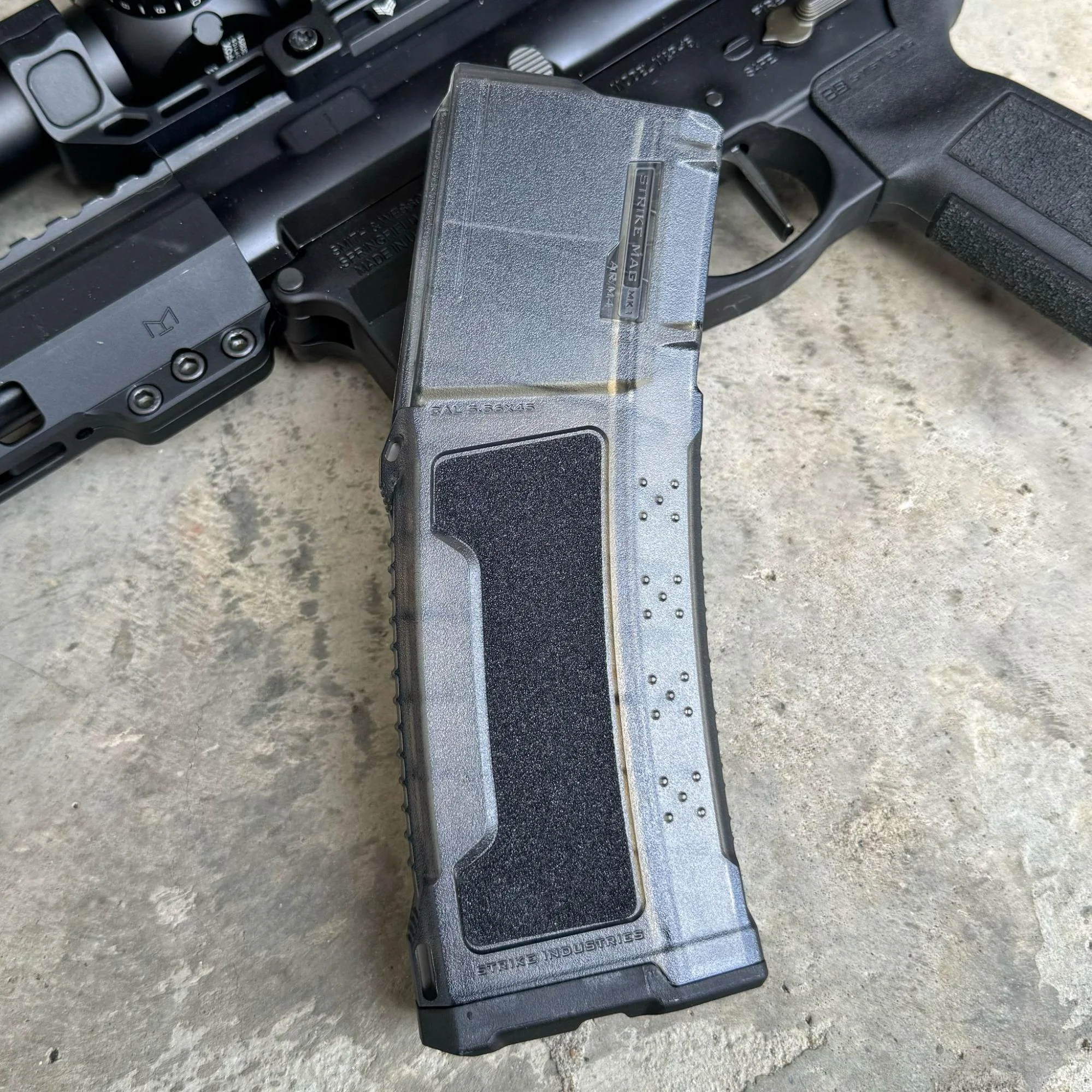 Strike AR-15 magazine equipped with optional grip inserts, enhancing its texture and usability
