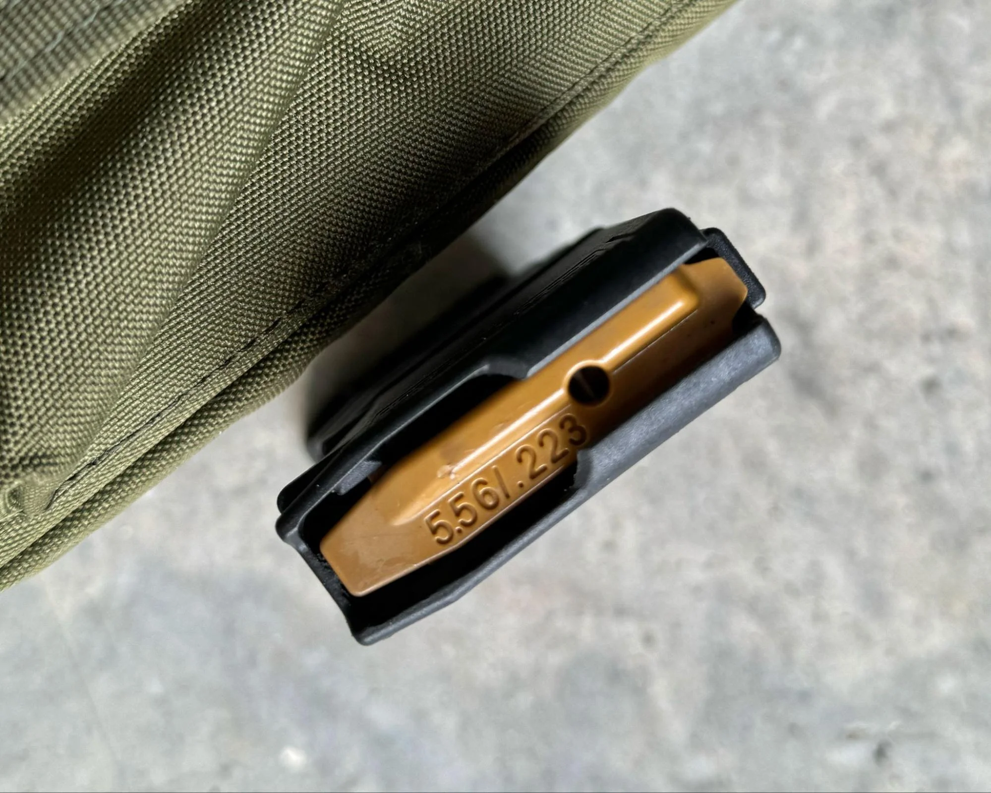 top of an Amend2 Mod-3 magazine with a distinctive burnt orange follower, aiding in quick identification of empty magazines