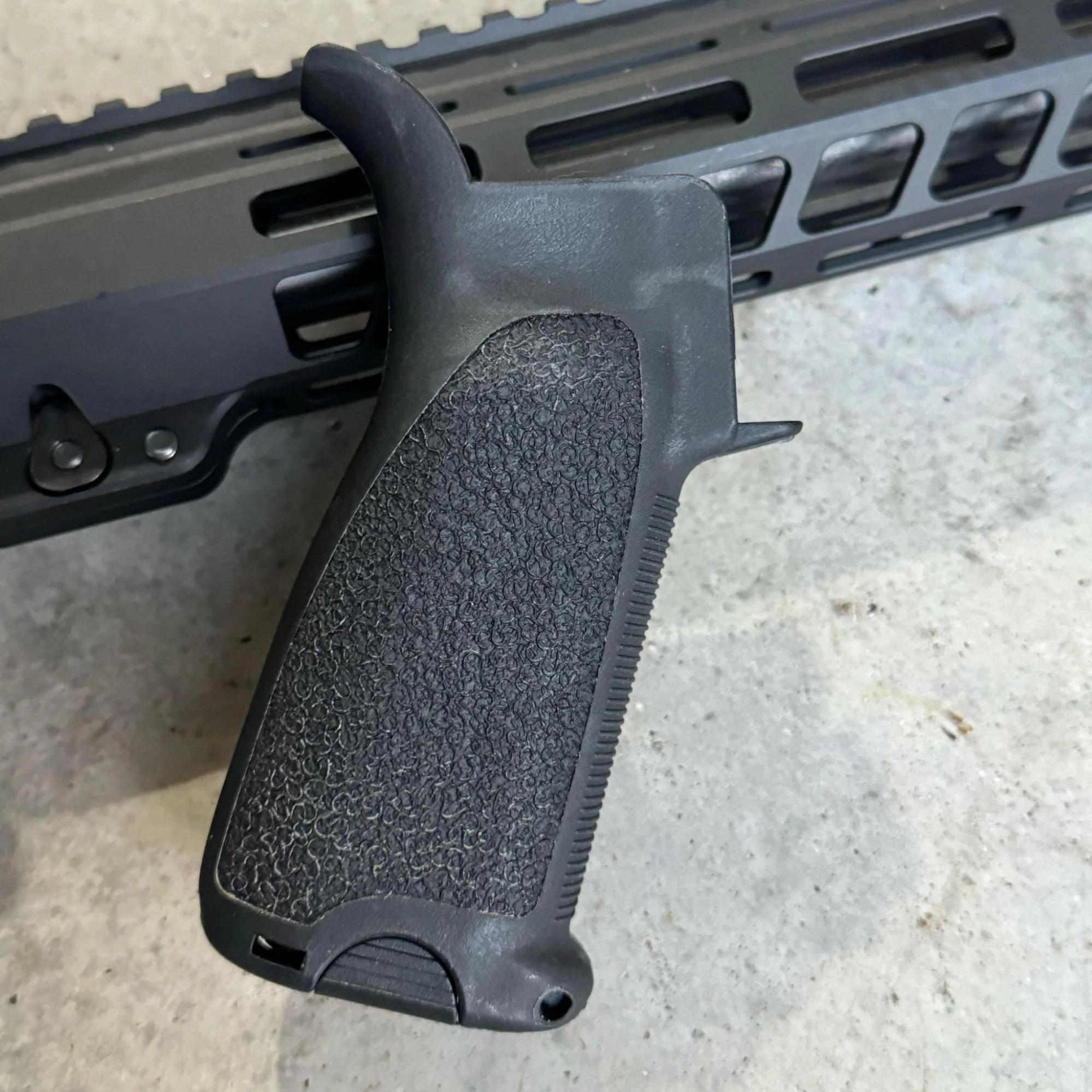 A photograph of the BCM Grip Mod 3 attached to an AR-15, illustrating its sleek and basic design that blends well with different rifle builds