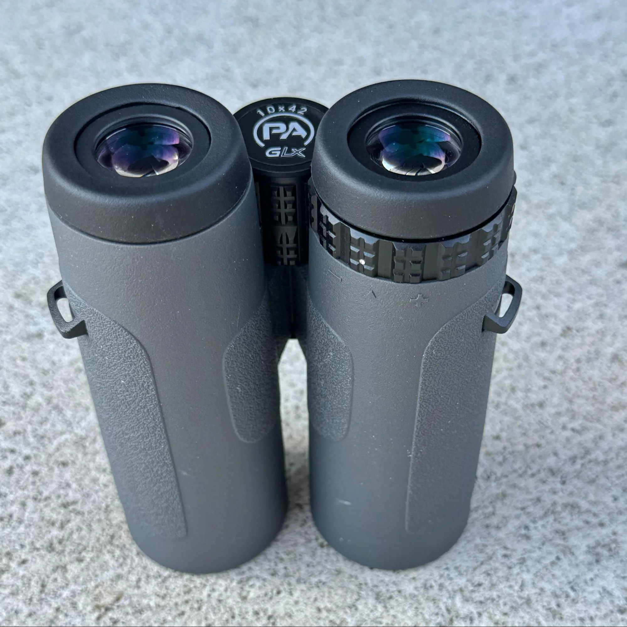 Image focusing on the sides of the GLx binoculars, highlighting the lanyard slots
