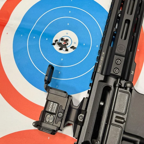 Tight groupings on a target shot using the Aimpoint Acro C-2, highlighting its accuracy