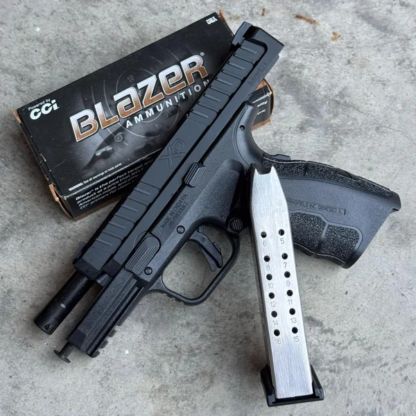 Image of the pistol with Blazer Brass ammo nearby