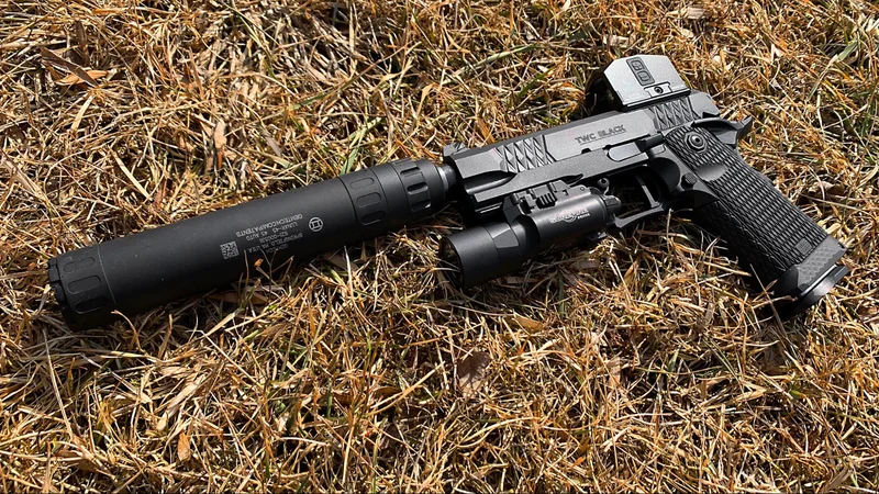 jacob grey twc black review gemtech 45 suppressor laying in field