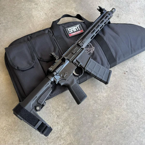 Springfield Armory Saint Victor 5.56 Pistol with SB Tactical brace and Magpul magazine on a branded soft case