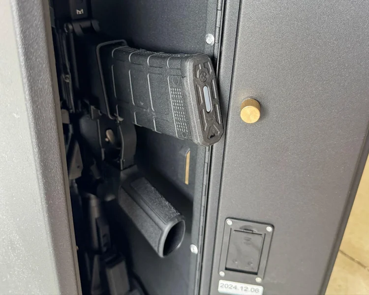 AR-15 rifle inside the SecureIt safe with a 30-round magazine slightly extending beyond the interior fit