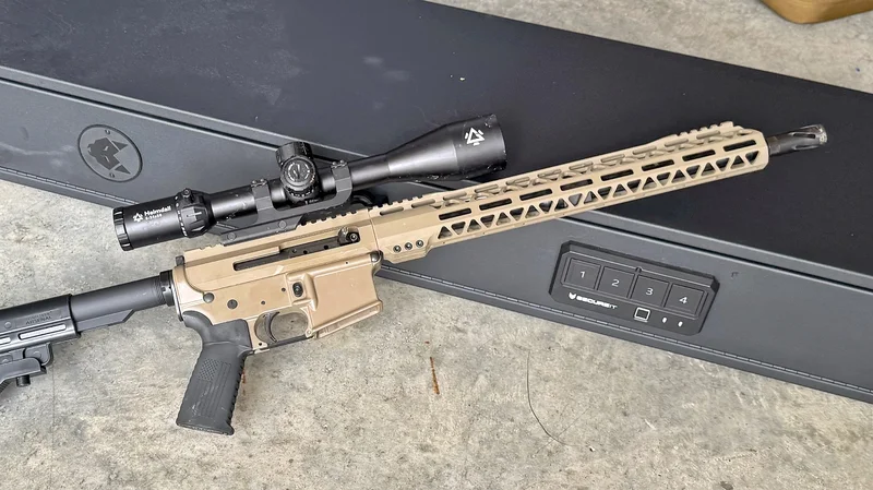 AR-15 rifle with mounted optic resting on top of the SecureIt Fast Box Model 47 gun safe