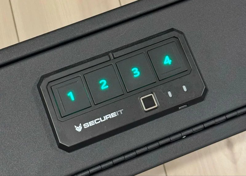 Close-up of the SecureIt keypad with green backlit buttons for code entry and fingerprint scanning