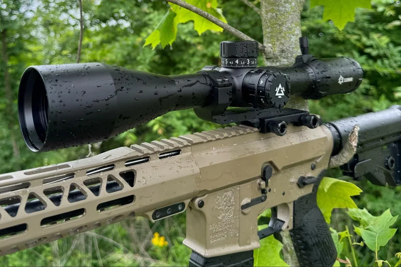 HEIMDALL rifle scope mounted on a rifle in a rainy outdoor setting