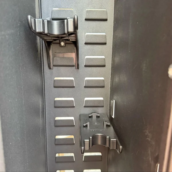 Interior view of the SecureIt safe showing adjustable Cradlegrid brackets for securely storing rifles and pistols.