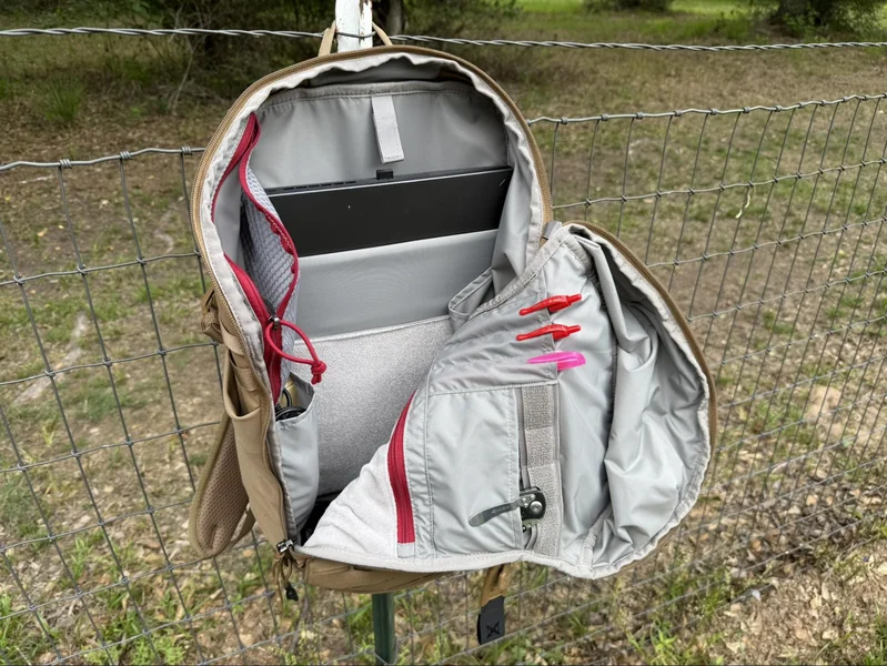 Interior view of the Vertx Siege 25L backpack showing organized storage compartments, laptop sleeve, pen holders, and zippered pockets.