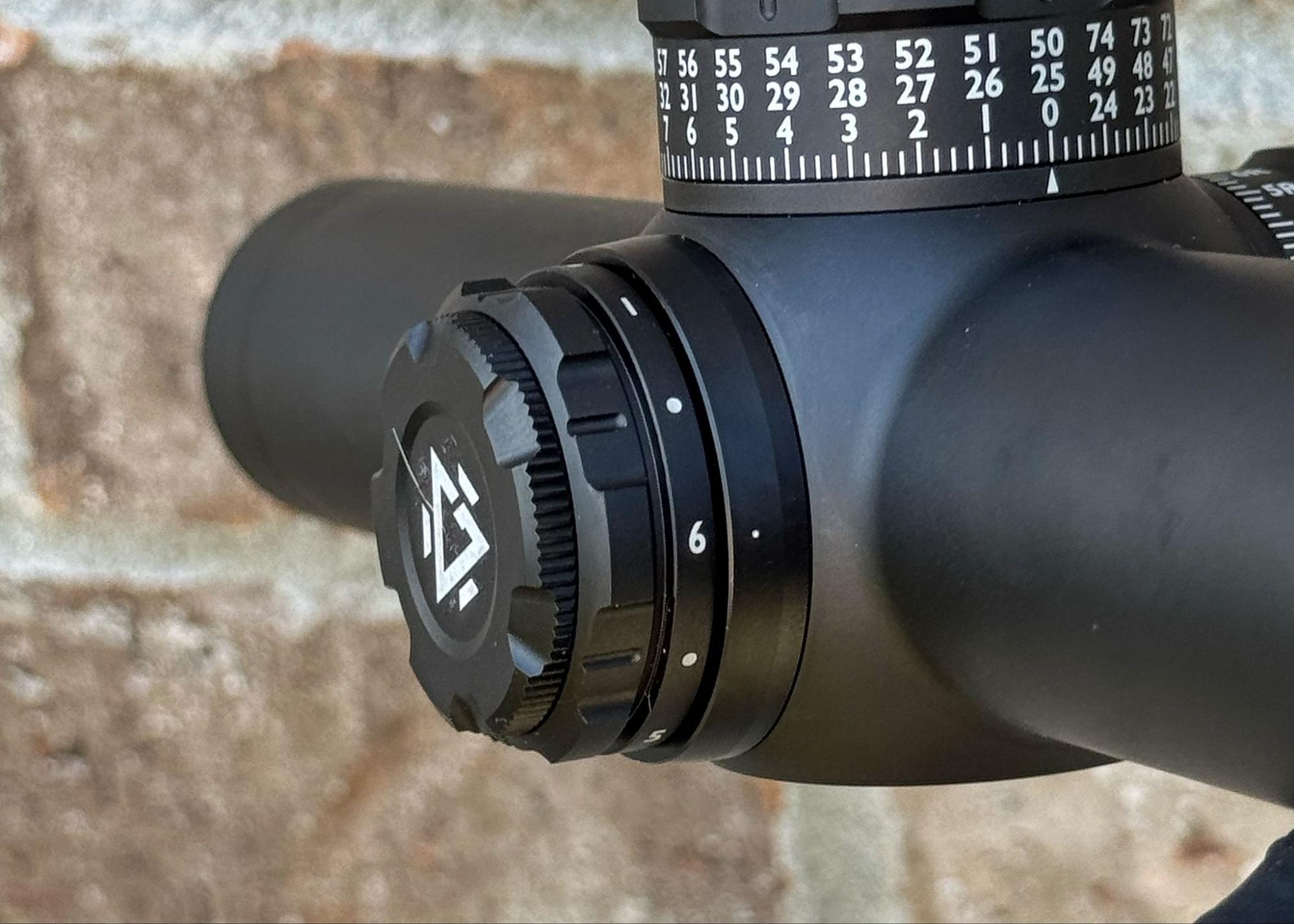 Close-up of the GUNNR Odin LPVO brightness adjustment dial set near maximum, with turret markings visible