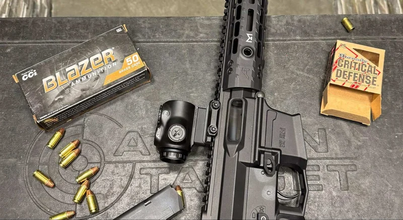 Top-down view of Aero EPC9 rifle with GLx 1x optic, surrounded by Blazer and Hornady ammo boxes and scattered rounds.