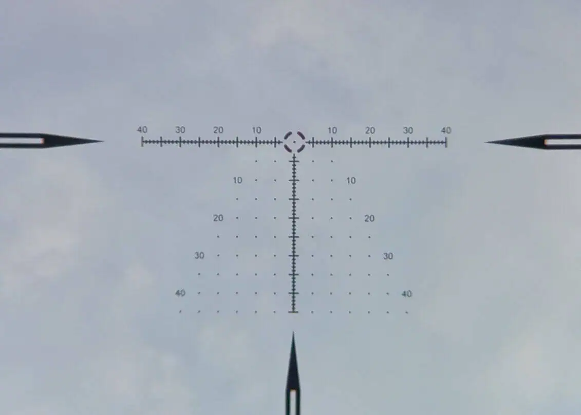 View through the GUNNR Odin LPVO at full magnification, showing detailed reticle with hash marks for precise aiming