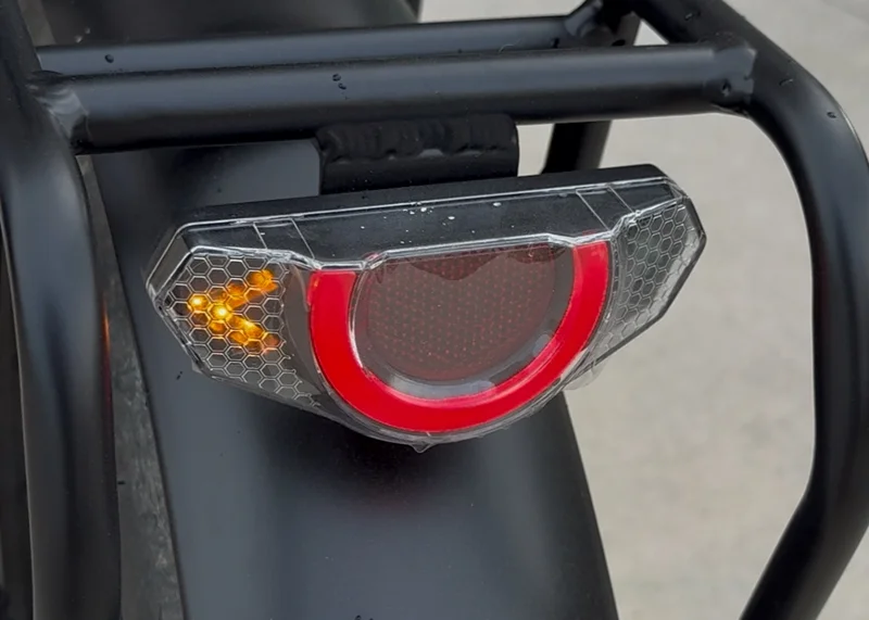 Close-up of Birch Grolar AWD taillight and active turn signal, highlighting included safety lighting and signaling features.