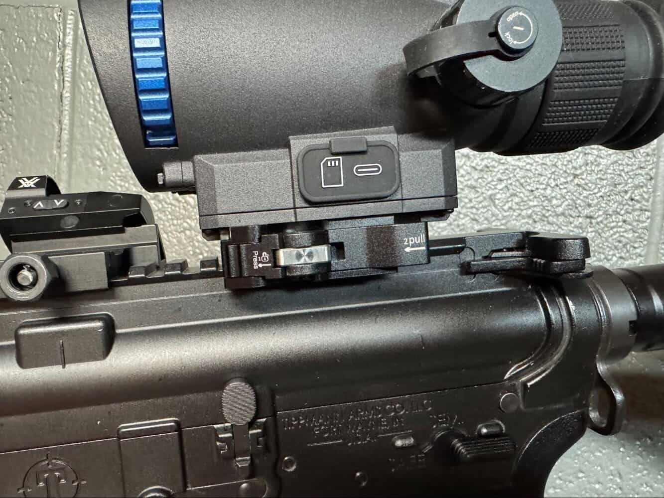 Close-up of Goyojo GRL335 thermal scope quick-detach mount on AR rifle for fast optic swapping