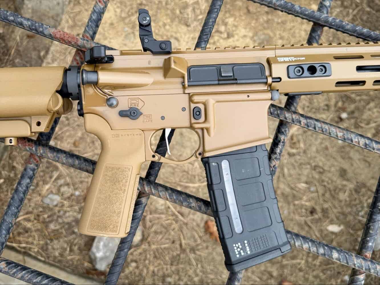 Close-up of Springfield Armory Saint Victor V2 rifle in Coyote Brown finish showing receiver, grip, and magazine