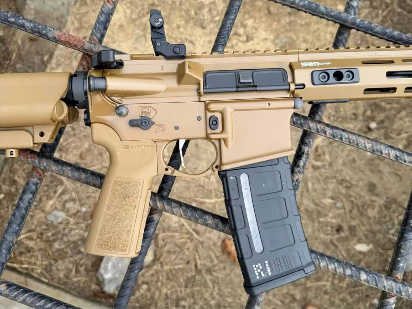 Close-up of Springfield Armory Saint Victor V2 rifle in Coyote Brown finish showing receiver, grip, and magazine