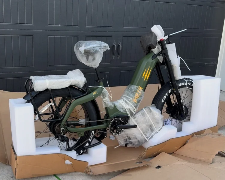 Partially assembled Birch Grolar AWD hunting bike in packaging foam, showing minimal setup required after delivery.
