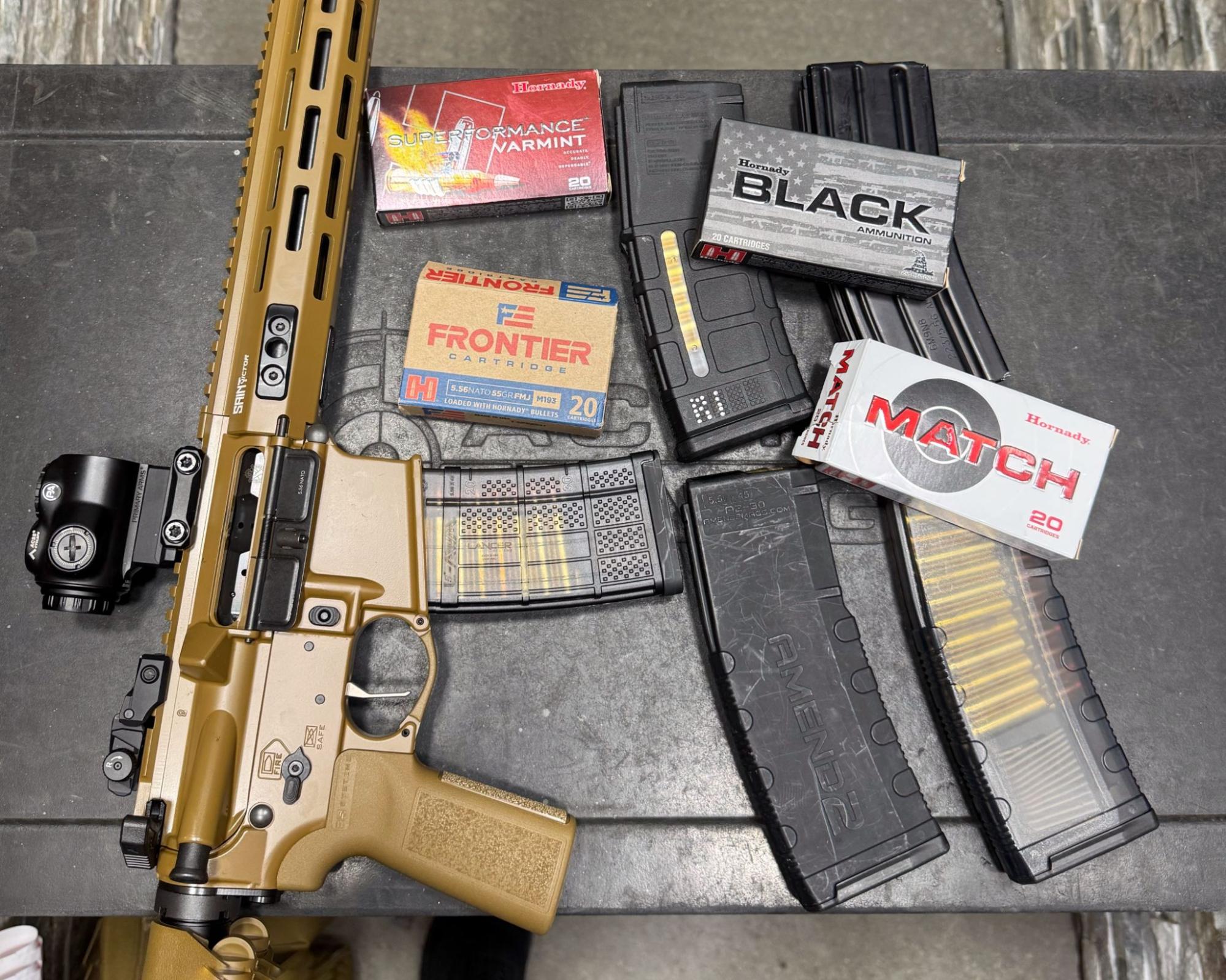 Springfield Saint Victor V2 rifle on shooting bench with Hornady and PMC ammo boxes