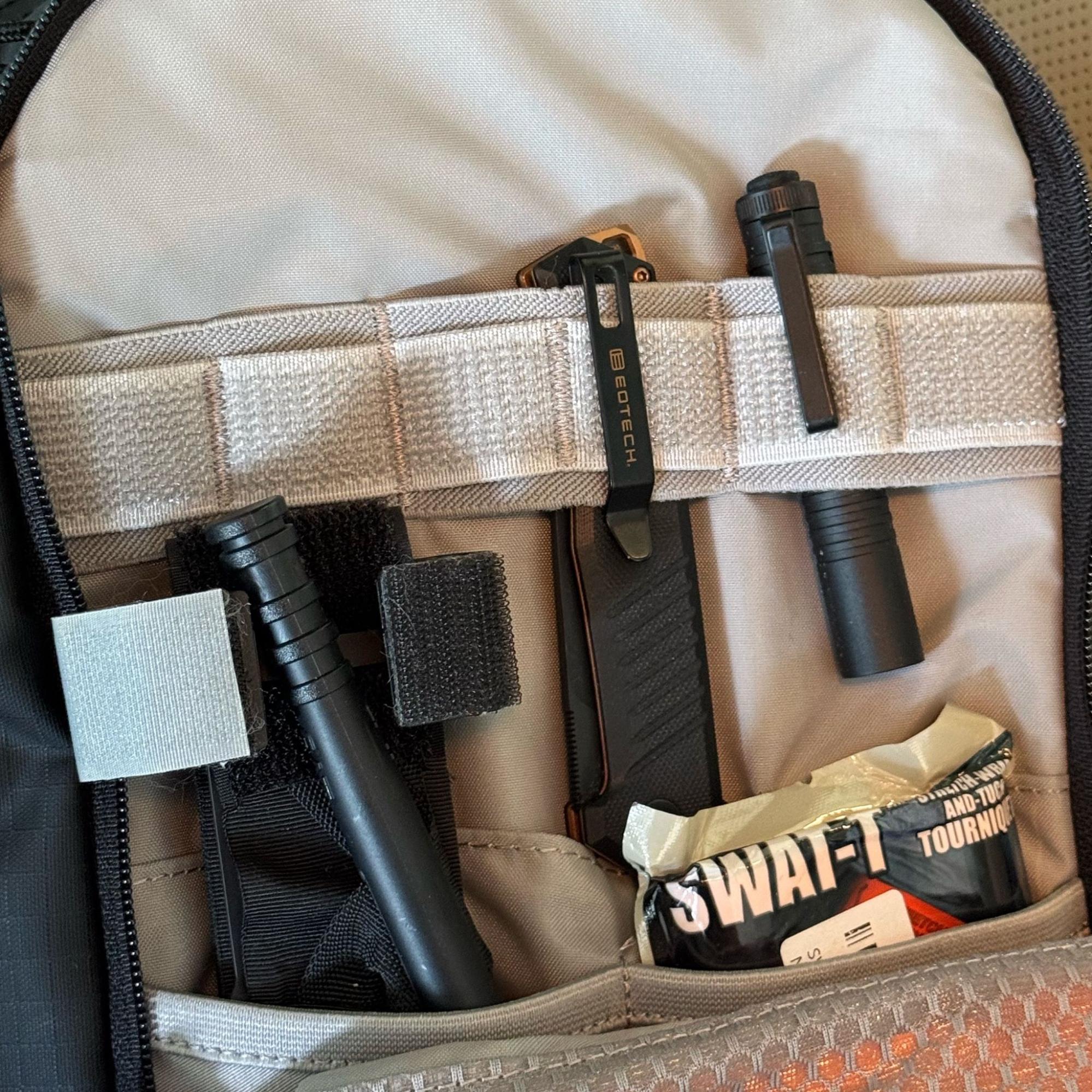 Tekto F1 Alpha EOTECH knife clipped inside backpack pouch next to Streamlight Microstream flashlight