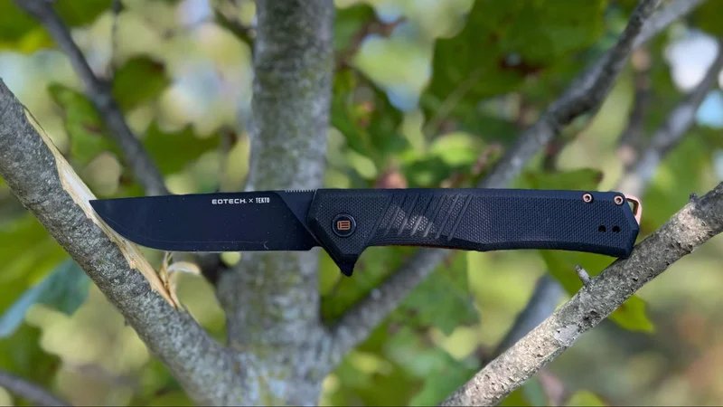 Tekto F1 Alpha EOTECH knife shown on paper with cut marks and handwritten 'Tekto F1' text