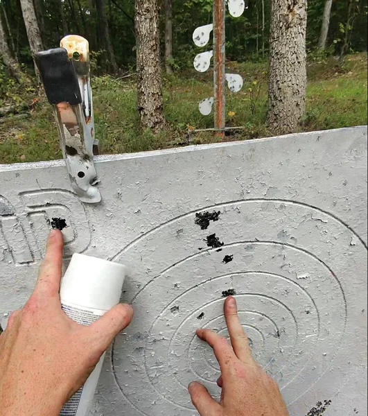 Steel-target-showing-tight-10-round-grouping-from-Rock-River-Arms-LAR-15M-rifle-at-50-yards-e1762783300288