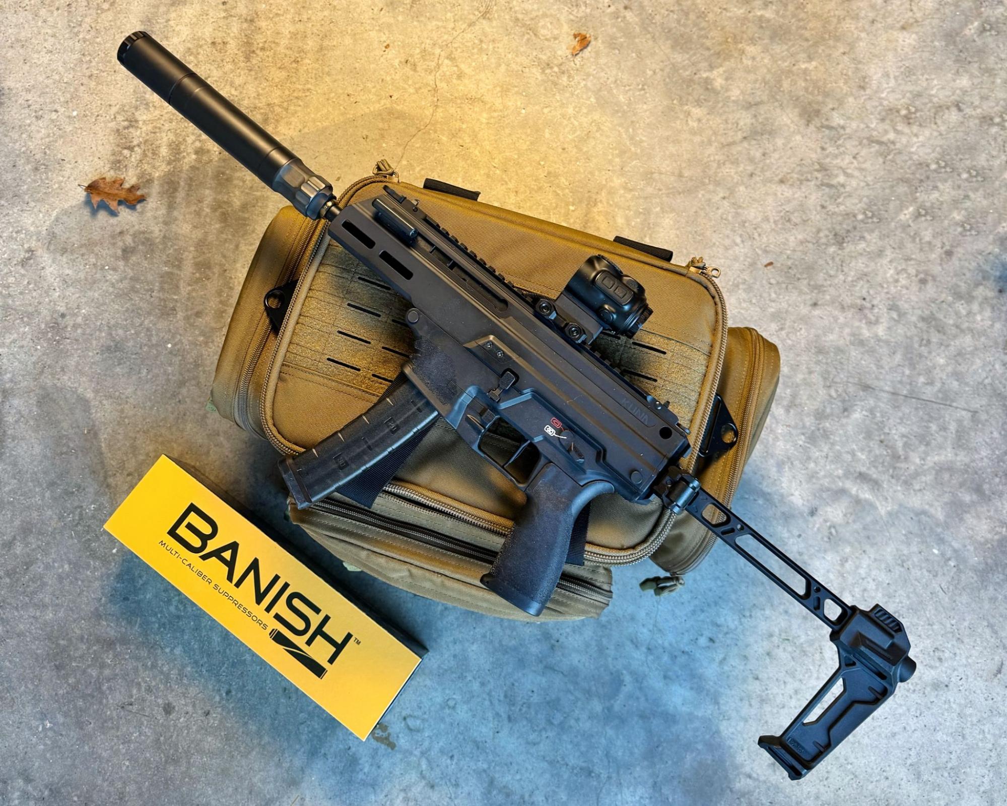 BANISH 45 suppressor mounted on PCC next to branded case and box