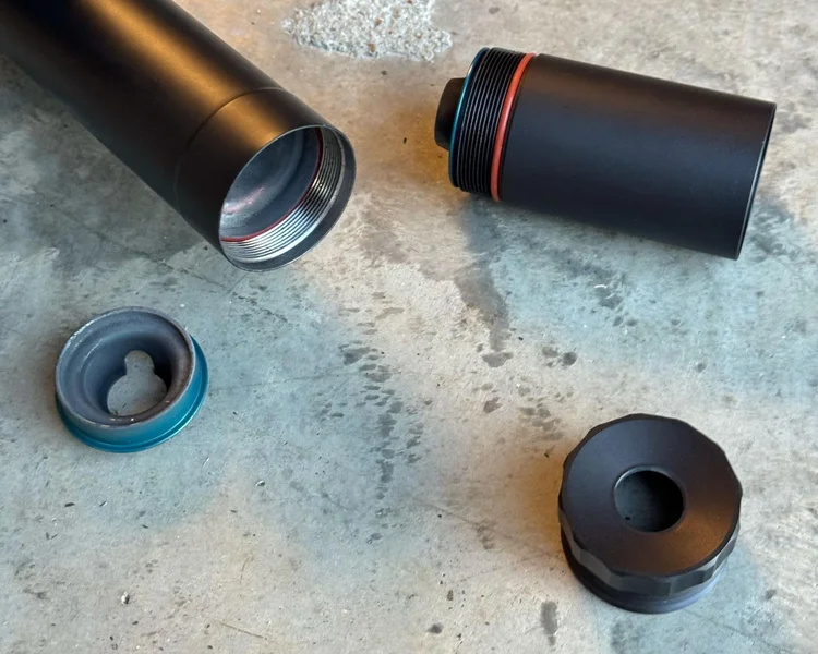 Close-up of BANISH 45 suppressor in short configuration with disassembled end caps and internal components