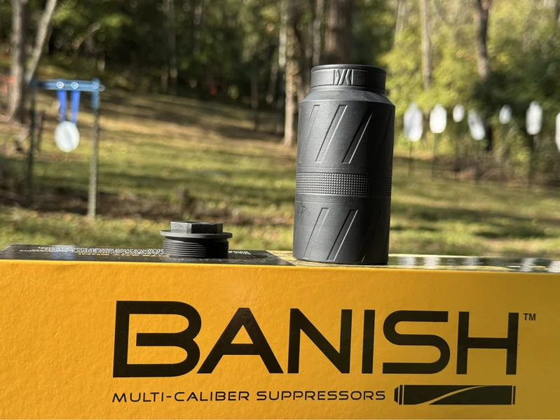 Close-up of BANISH Speed K suppressor and mount on yellow Banish box outdoors