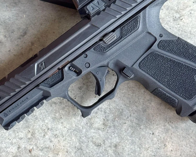 Detailed view of the unique trigger guard cuts and sizable undercut on the Strike Arms frame.