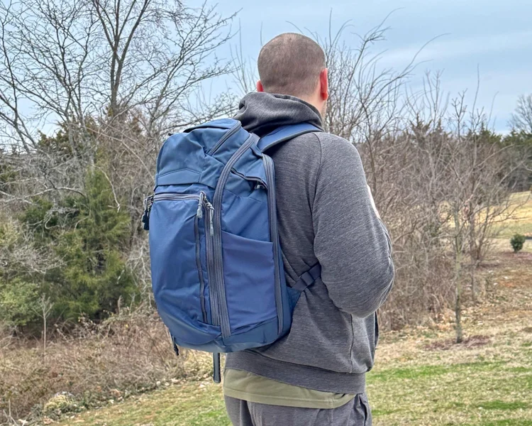 Man wearing a blue Vertx Gamut 26L backpack as an everyday carry (EDC) bag