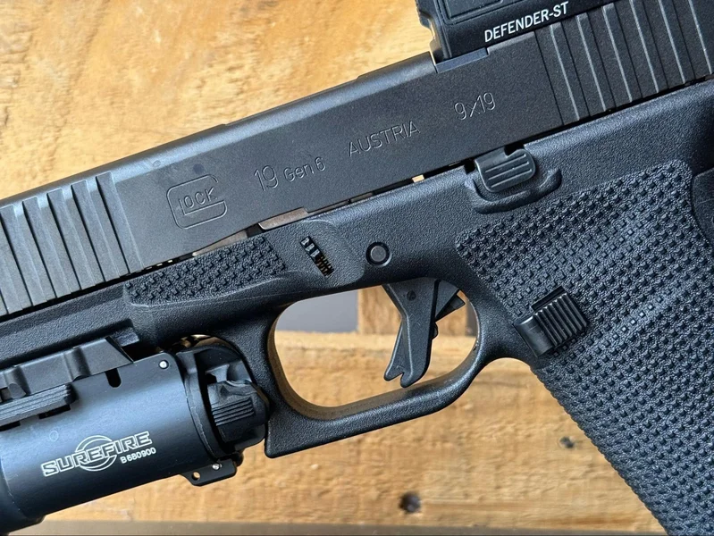 Close-up of the new factory-standard flat-faced trigger on the Glock 19 Gen6