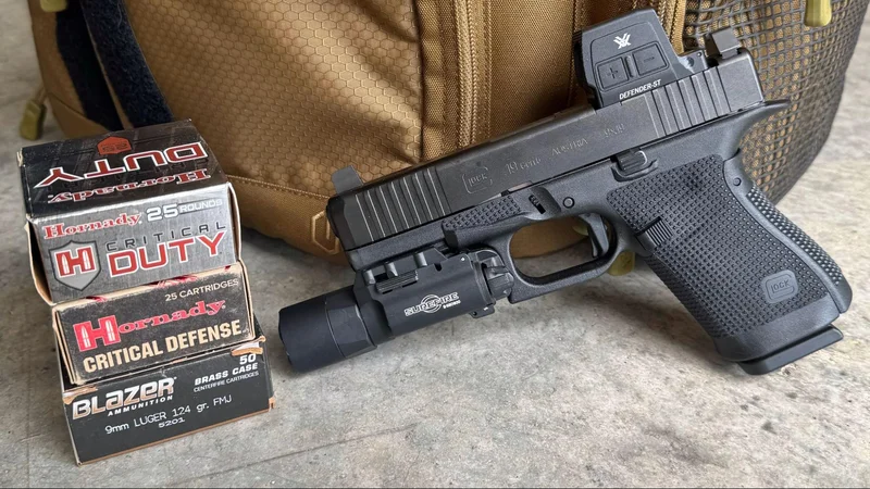 Glock 19 Gen6 with Vortex optic and Surefire light next to boxes of Hornady Critical Duty and Blazer Brass 9mm ammunition