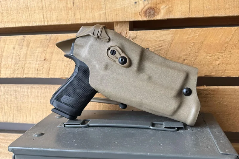 The Glock 19 Gen6 seated securely in a tan Safariland holster, demonstrating compatibility with Gen5 holsters.