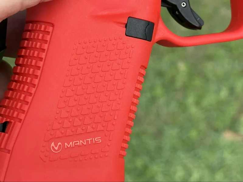 Close-up of the polymer grip texturing and Mantis logo on the TitanX frame for a secure training hold