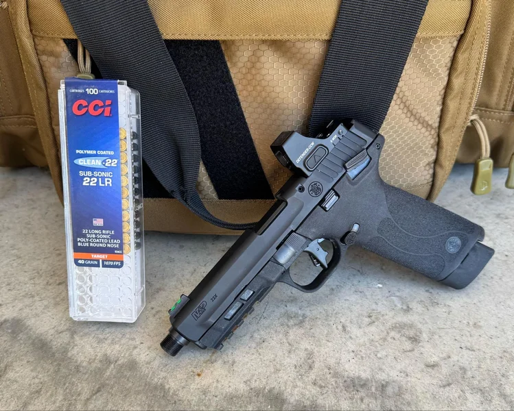 Smith & Wesson M&P22X .22 LR pistol next to a box of CCI Clean-22 Subsonic rimfire ammunition